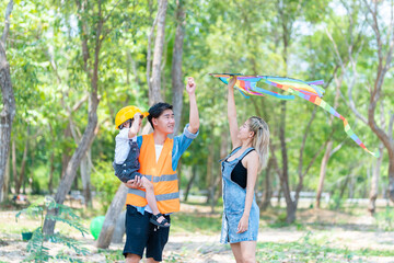 Obraz premium family happy in nature in summer parents and son fly a kite