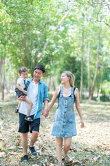 Family enjoying a camping holiday in the countryside ,Camping, travel, tourism, hiking and people. Concept - Happy family with backpacks and thermos at camp.