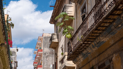 old architecture residential building with balcony in facade