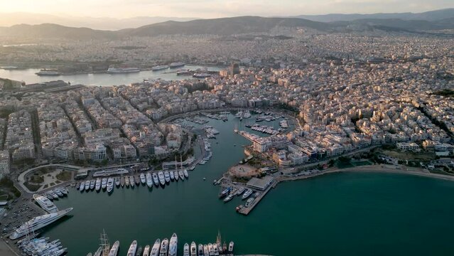 Aerial panorama of the Piraeus district in Athens, Greece, with Zea Marina and the ferry boat harbour in the background during sunset time