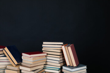 stacks of books scientific literature knowledge in the library on a black background