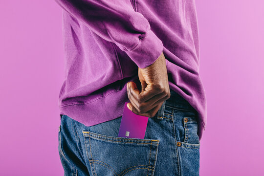 Lifestyle of electronic banking: Man pulls a purple credit card out of his pocket to make a payment