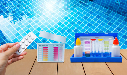 Two type of water tester test kit over clear swimming pool water, best water quality, pool...