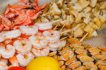 Shrimp, mussel meat and rapana cooked on wooden skewers