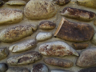 wall of oval stones brownish grayish white stones