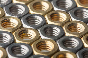 Metallic hex nuts layed out in a hexagonal pattern