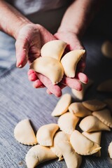 Baker working the bread dough and showing un baked empanadas - Pastry Making