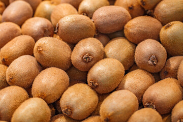 Kiwi fruit brown, whole in bulk, on supermarket, selective focus