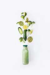 smoothie making , splash green vegetables , green vegetables and fruits with smoothy  bottle