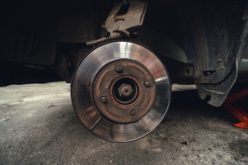 Old Disk brake and car service concept - Vehicle brake pad replacement service by hand of mechanic...