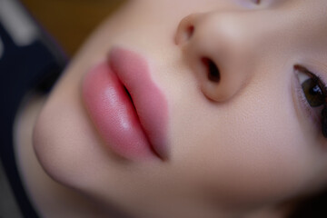 Close-up of a beautiful girl's lips before a permanent lip makeup procedure