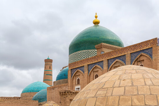 Khiva domes. Pahlavan-Mahmud necropolis at the Ichan-Qala, Juma mosque and minaret at background. Khiva (Xiva), ancient city at Silk Road. Uzbekistan