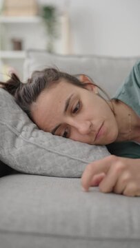 Sad Hispanic Young Woman With Depression Overthinking On Sofa.