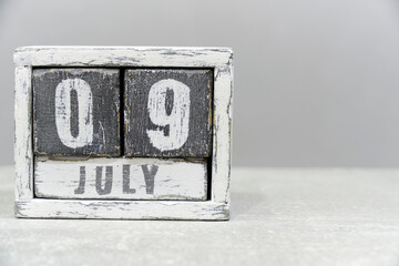 Calendar for July 09, made of wooden cubes, on gray background.With an empty space for your text.Independence of Argentina.