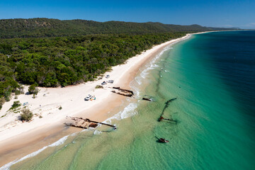 Shipwrecks and offroad vehicles on pristine beach at Moreton Island