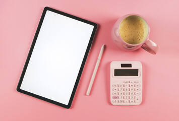 flat lay of digital tablet with blank white screen, pink stylus pen,  pink cup of coffee,  and pink  calculator  isolated on pink background.