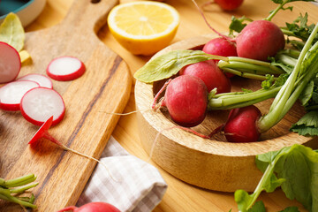 Fresh red radish in bowl on a wooden background. Close-up.
