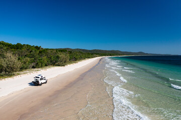 4WD off-road vehicle driving on beach, Moreton Island, Queensland