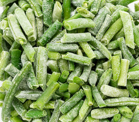 Frozen cut green string beans close up as background. Real food. Sustainable consumption. Top view.
