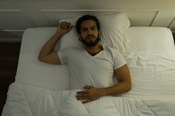 Fototapeta premium Top view of a latin man suffering from insomnia
