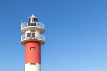 Fototapeta na wymiar Faro del Fangar (Fangar Lighthouse) in Punta del Fangar, Spain. Solar panels.