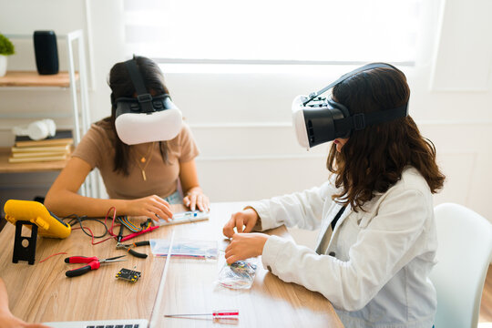 Teen students having fun with virtual reality and learning in school