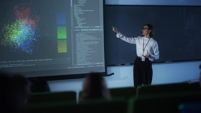 Portrait of a Young University Professor Explaining the Importance of Artificial Intelligence to a Group of Diverse Students. Female Teacher Showing Big Data Ecosystem on a Big Screen