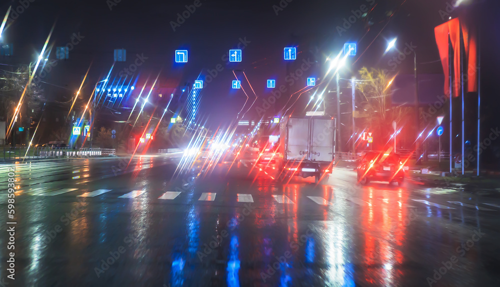 Poster Car traffic at night in the rain on a city