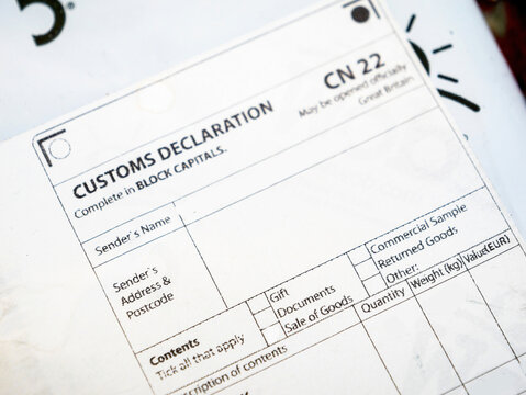 A document for commercial shipping, with details such as quantity, value and weight filled in a CN22 form. A sticker on the parcel to declare customs content and finance information for e-commerce.