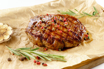 Aged barbecue beef steak close up on wooden background. banner, menu.