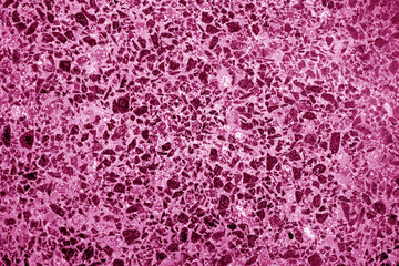 Cement with gravel stones surface in pink tone.