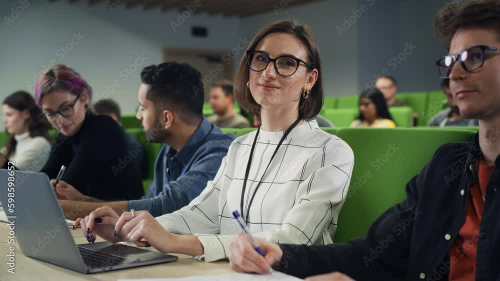 Poster portrait of a happy young caucasian female in glasses looking at camera and smiling. young female st
