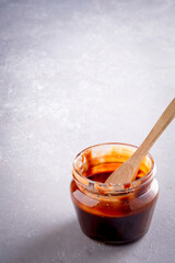 Caramel jam and spoon on vintage background