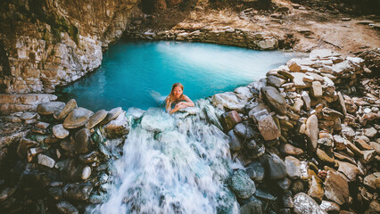Woman bathing in a hot spring outdoor travel in Albania, Benja thermal bath girl relaxing in natural pool summer vacations healthy lifestyle - obrazy, fototapety, plakaty