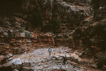 Man exploring Jacobs canyon in Rhodes, Greece traveler hiking solo travel lifestyle active vacations outdoor rocks wilderness nature