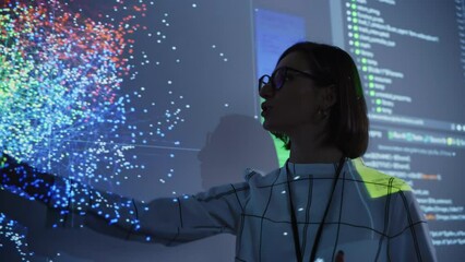 Young Female Teacher Giving a Data Science Presentation in a Dark Auditorium with Projecting Slideshow with Artificial Intelligence Neural Network Architecture. Business Startup and Education Concept