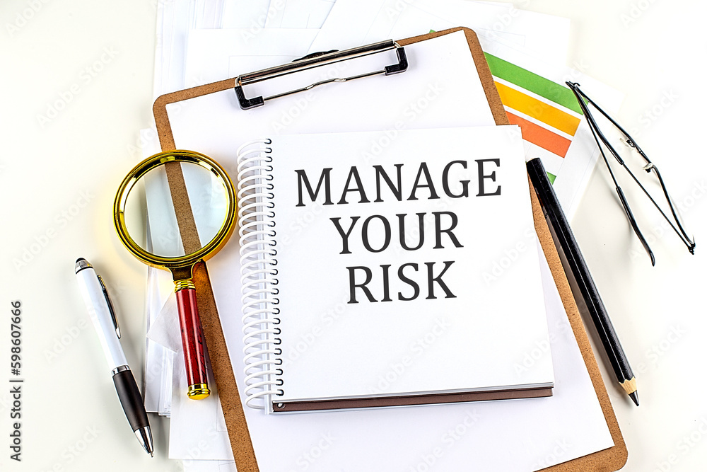 Poster manage your risk text on notebook with clipboard on white background