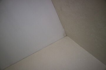a corner of the wall of a room with white paint