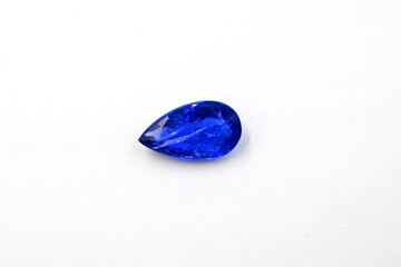 Obraz na płótnie Canvas Tanzanite blue pear facet gemstone isolated on white background