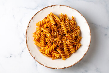 Fusilli pasta, spiral or spirali pasta with tomato, minced sauce - Italian food style