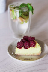 Slice of raspberry cake and non-alcoholic mojito in the cafe. Summer food