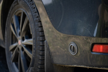 Car with lpg liquid gas tank, close-up photo, filling valve for gas.