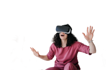 Amazed curly caucasian young woman in lilac clothes sitting on bed spreading hands using vr glasses at bedroom. Happy girl in virtual reality headset having fun against transparent background.