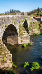 Fototapeta na wymiar A Ponte Maceira, Galicia, Spain - April 4, 2023: Roman stone bridge over the River Tambre