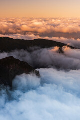 Madeira mountains landscape with peaks above clouds at sunset