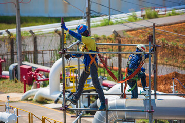 Architect on site construction workers on a scaffold pipeline