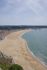 Nazare, Portugal - March 28, 2023: Wonderful landscapes in Portugal. Scenic coastline in the center of Portugal, Nazare. View from the hill. Rippled sea. Sunny spring day. Selective focus