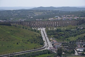 Elvas, Portugal - March 30, 2023: Wonderful landscapes in Portugal. Beautiful scenery of Amoreira Aqueduct in Elvas. 16th-century aqueduct. It brings water into the fortified seat. Selective focus