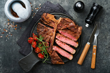 Steaks T-bone. Sliced beef grilled T-bone or porterhouse meat steak with spices rosemary and pepper...