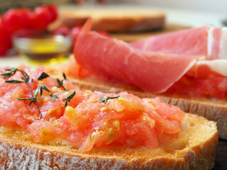 Toasts with tomatoes and ham. Close up
